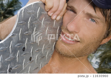 Hispanic man holding skateboard Hispanic man holding skateboard 11630960