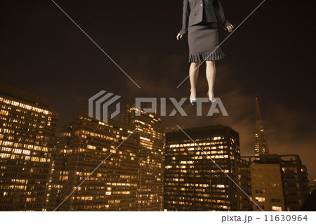 Businesswoman floating above the city 11630964