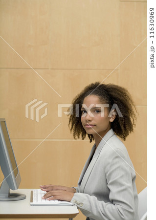 African businesswoman typing on computer 11630969