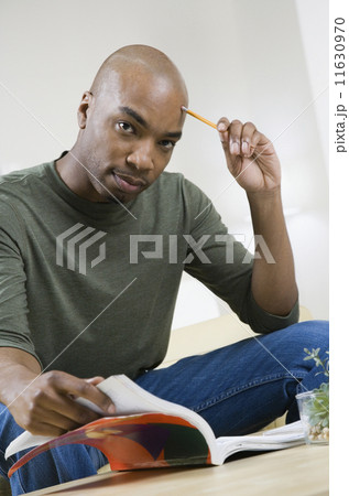African American man reading text book 11630970