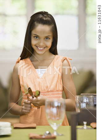 Hispanic girl setting table Hispanic girl setting table 11631043
