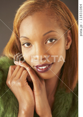 African woman resting chin on hands 11631064