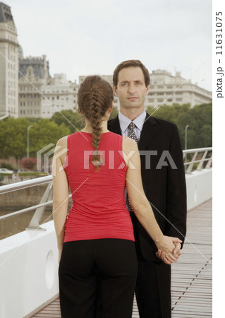 Multi-ethnic couple holding hands Multi-ethnic couple holding hands 11631075