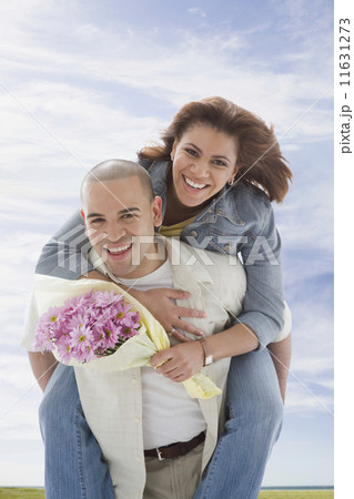 African American man giving girlfriend piggyback ride African American man giving girlfriend piggyback ride 11631273