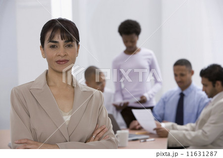 Indian businesswoman with co-workers in background 11631287