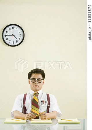 Nerdy Asian man sitting at desk Nerdy Asian man sitting at desk 11631376