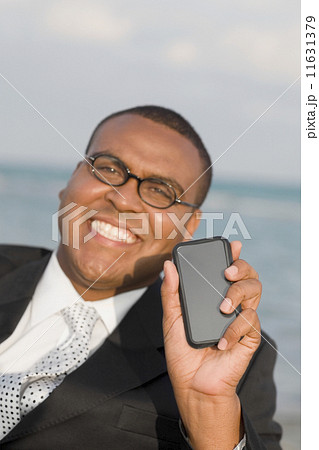 African businessman holding electronic organizer 11631379