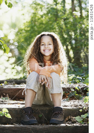 Young African girl smiling in woods 11631426