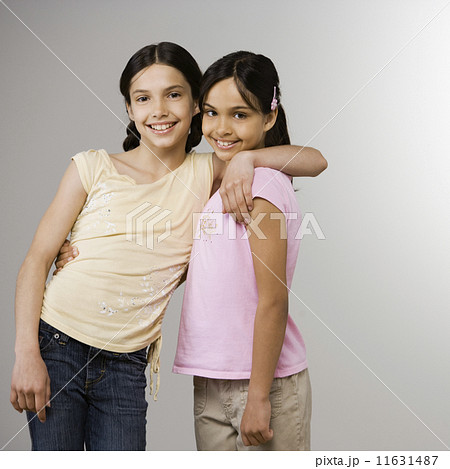 Hispanic sisters hugging 11631487