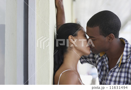 Multi-ethnic couple kissing Multi-ethnic couple kissing 11631494