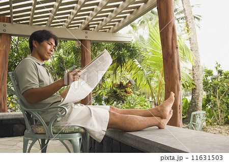 Asian man reading newspaper 11631503