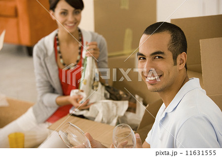 Young couple packing moving boxes Young couple packing moving boxes 11631555