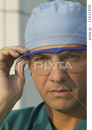 Hispanic male doctor wearing surgical glasses 11631606
