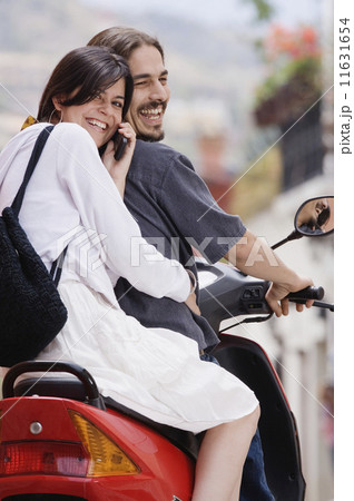 Hispanic couple on scooter Hispanic couple on scooter 11631654