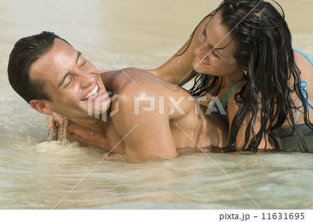 Hispanic couple playing in water Hispanic couple playing in water 11631695