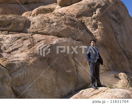 African businessman standing on rock 11631704