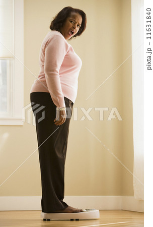 Woman weighing herself 11631840