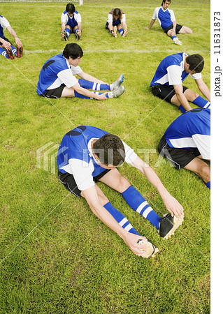 Multi-ethnic male soccer players stretching Multi-ethnic male soccer players stretching 11631873