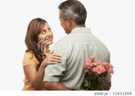 Hispanic man surprising wife with flowers Hispanic man surprising wife with flowers 11631908