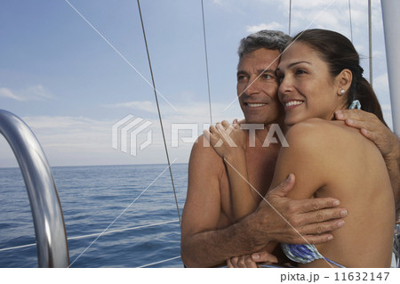 Multi-ethnic couple hugging 11632147