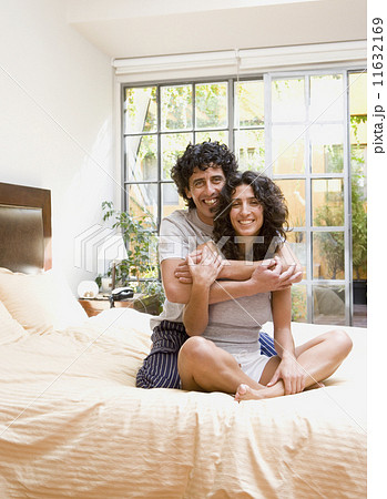 Couple hugging on bed Couple hugging on bed 11632169