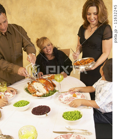 Hispanic family at holiday dinner table 11632245