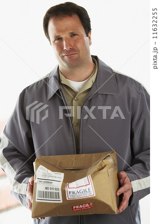 Man holding crushed package marked Fragile Man holding crushed package marked Fragile 11632255