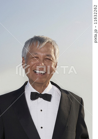 Senior Pacific Islander man wearing tuxedo 11632262