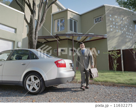Businessman walking out to his car 11632275