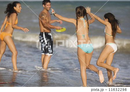 Hispanic family playing at beach Hispanic family playing at beach 11632298