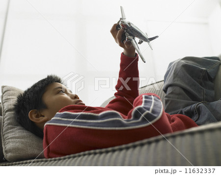 Young boy playing with a model plane Young boy playing with a model plane 11632337