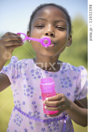 African girl blowing bubbles 11632398