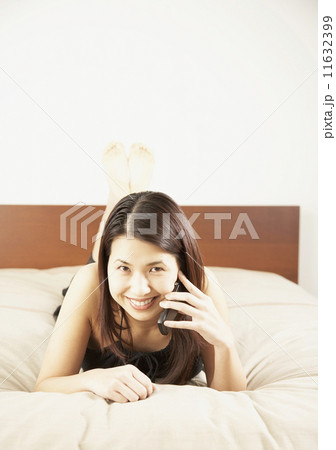Asian woman talking on cell phone 11632399