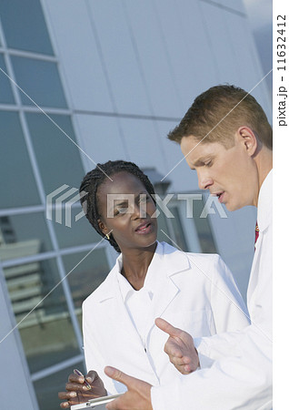 Two medical professionals discussing chart Two medical professionals discussing chart 11632412