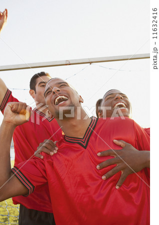 Teammates cheering and hugging Teammates cheering and hugging 11632416