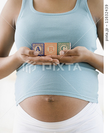 Pregnant African American woman holding ABC blocks 11632439