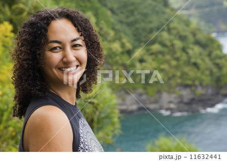 African American woman on cliff over water 11632441