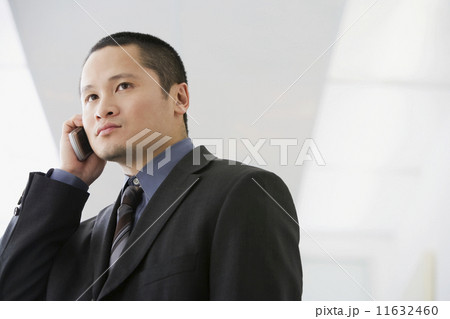 Asian businessman talking on cell phone 11632460