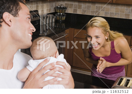 Hispanic mother smiling at baby 11632512