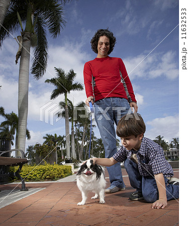 Hispanic father and son with dog 11632533