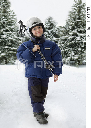 Mixed Race boy holding ski poles 11632534