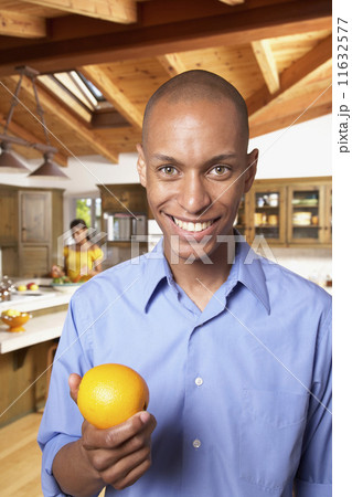 African man holding fruit 11632577