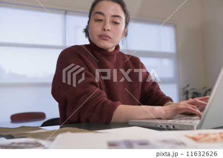 Mixed Race woman typing on laptop Mixed Race woman typing on laptop 11632626