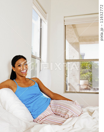 Indian woman sitting in bed 11632772