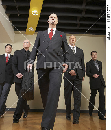 Multi-ethnic businessmen walking in formation 11632775
