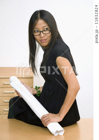 Asian businesswoman holding blueprints Asian businesswoman holding blueprints 11632824