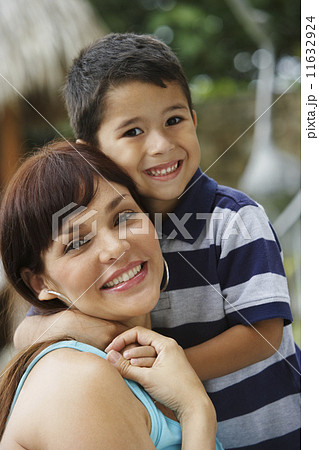 Hispanic mother and son hugging 11632924