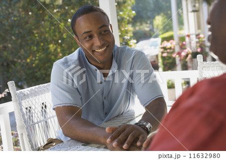 African American man sitting on porch 11632980