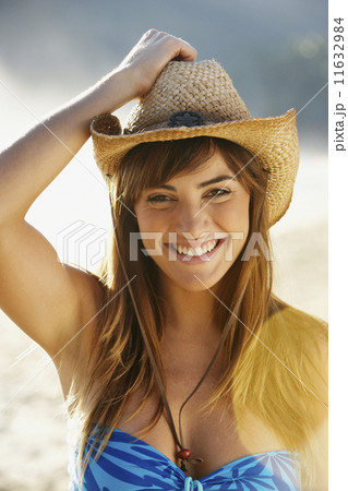 Smiling woman in straw cowboy hat 11632984