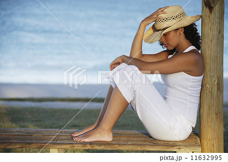 Mixed Race woman wearing straw hat 11632995